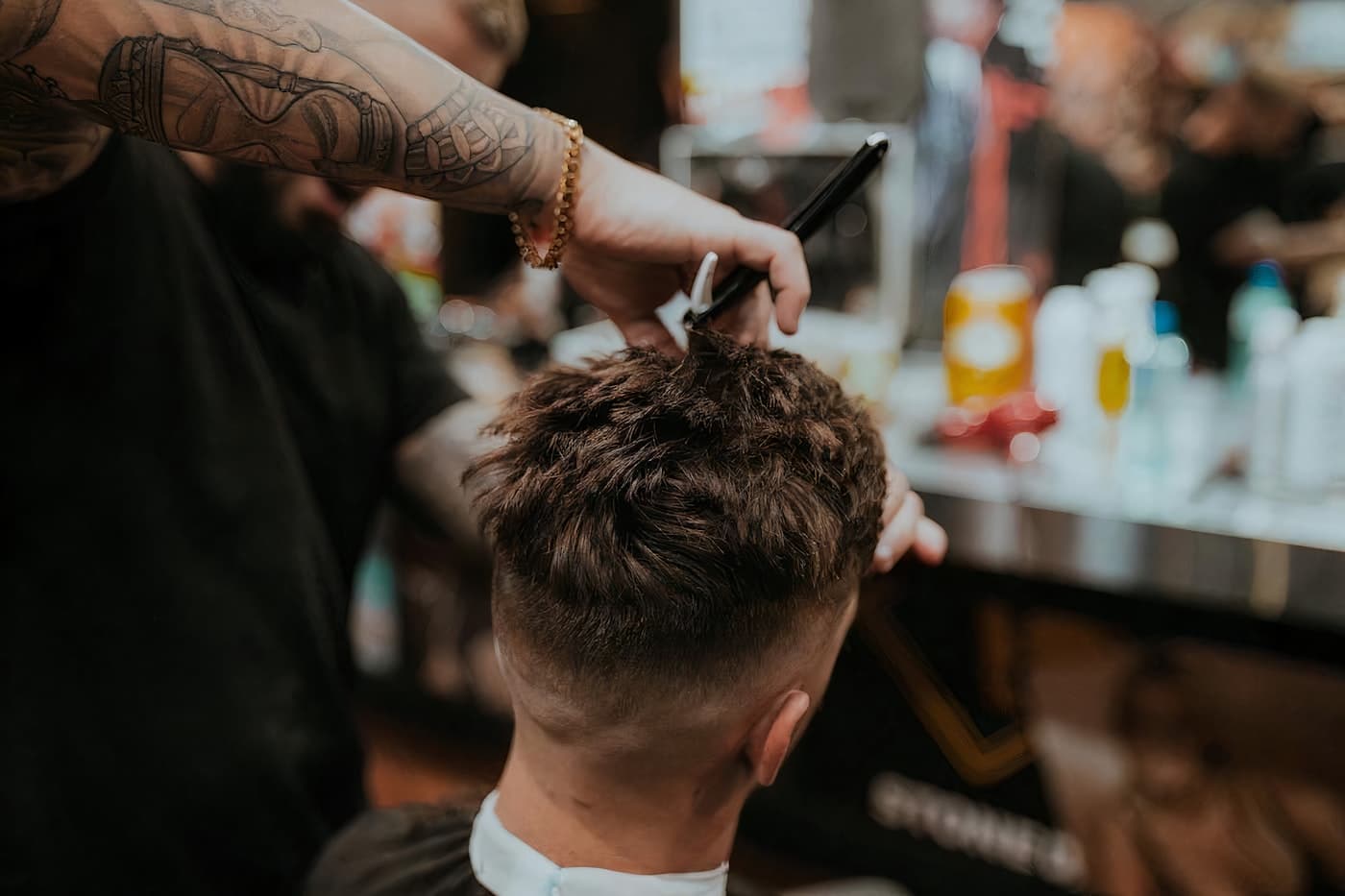 A man receiving a precise haircut in a barber's chair