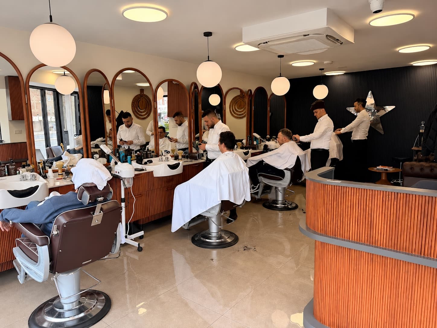 Inside Mr. Star's Grooming Atelier on Kensington High Street, barbers at work